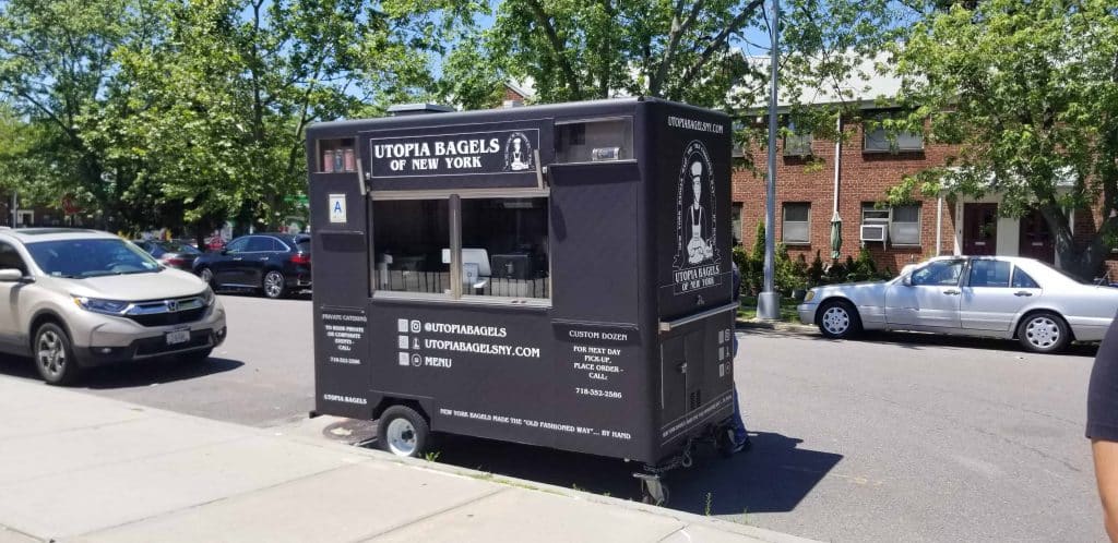 utopia bagels food cart fitting in a street parking space