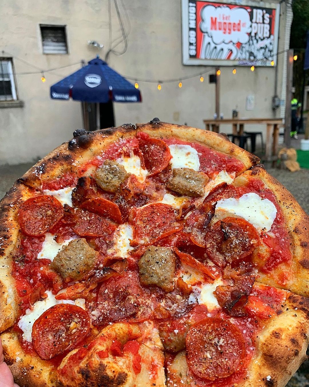 Pepperoni, sausage, and mozzarella wood fired pizza from food truck.