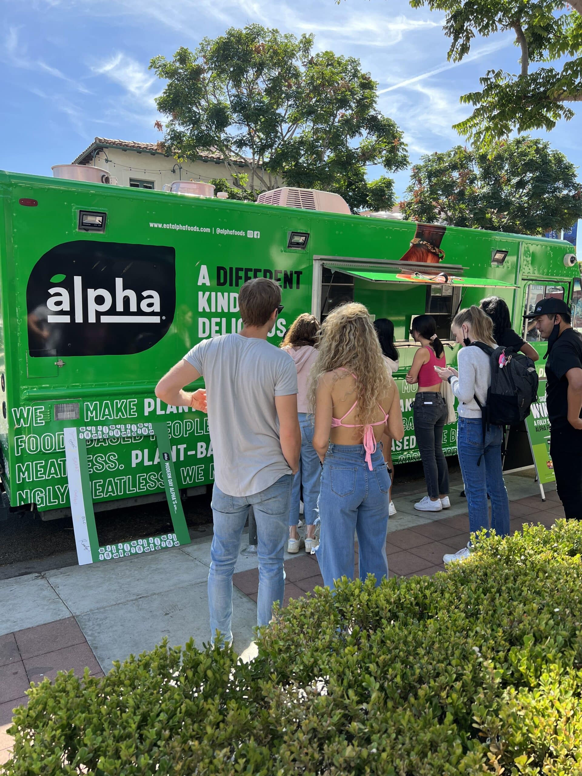 Students in front of Alpha Foods branded food truck