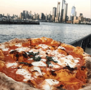 Pizza Vita in front of NYC skyline.