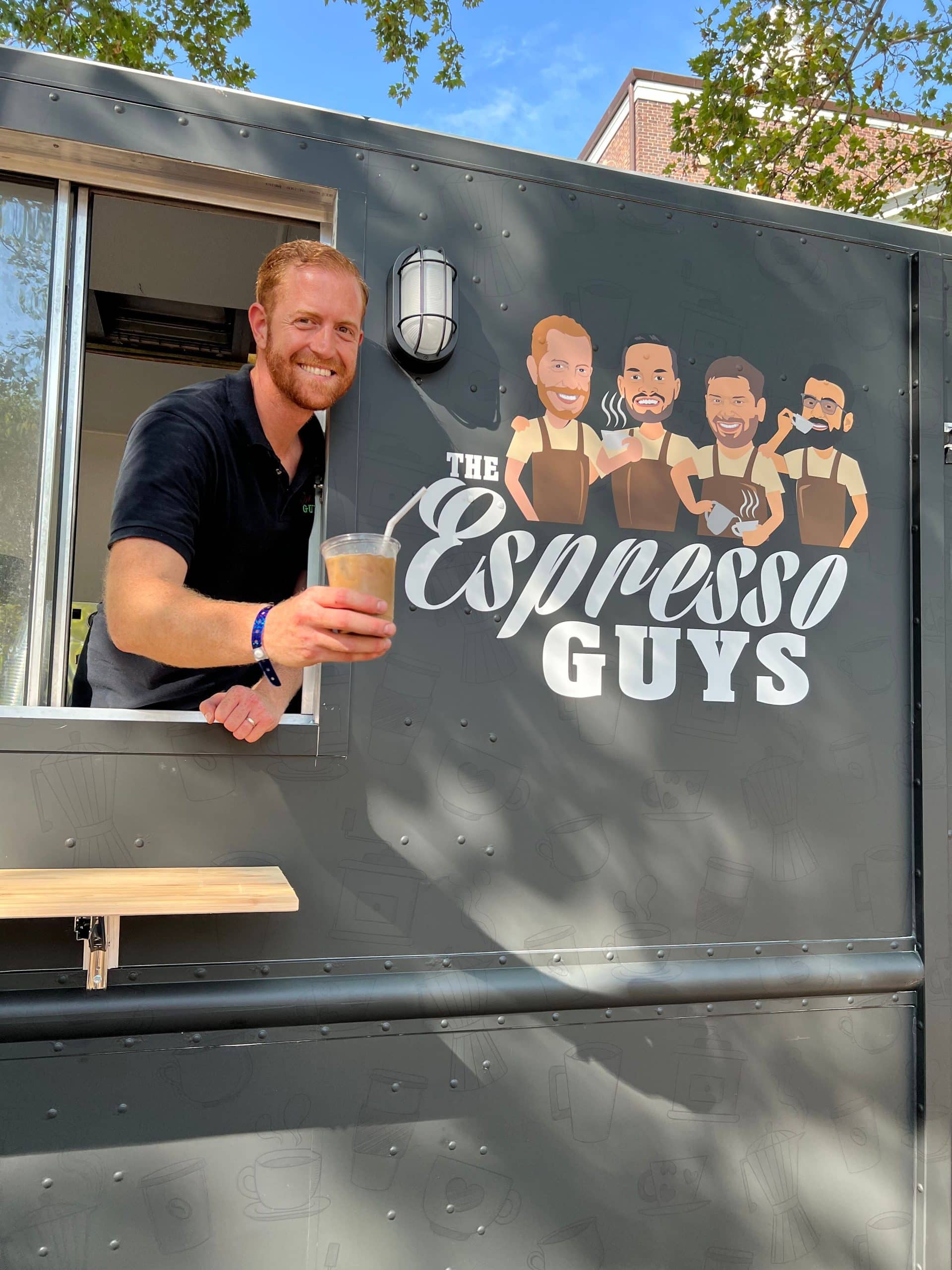 Espresso guys food truck owner holding coffee from food truck window